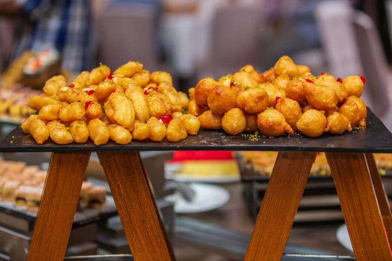 a bunch of food sitting on top of a table, by Julia Pishtar, crispy buns, frying nails, up close, square