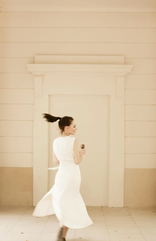 a woman in a white dress holding an umbrella, inspired by Francesco Hayez, minimalism, running towards camera, colonnade, wedding, hair in a ponytail