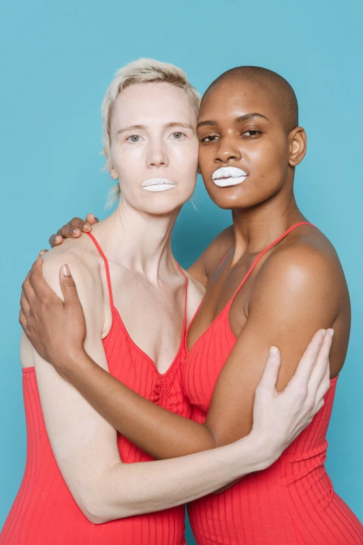 two women in red dresses hugging each other, inspired by Vanessa Beecroft, unsplash, white face paint, big lips, a bald, pride