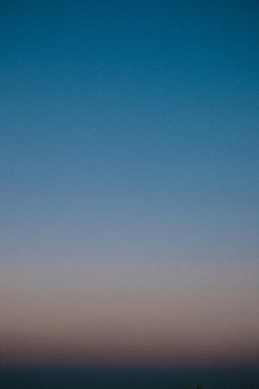 a man flying a kite on top of a beach, a minimalist painting, inspired by Jan Rustem, unsplash, postminimalism, photography shot at blue hour, sunset on mars, gradient sapphire, f4.0 120mm