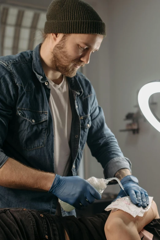 a man getting a tattoo on a woman's chest, a hyperrealistic painting, trending on pexels, process art, blue gloves, made of lab tissue, inspect in inventory image, soap carving