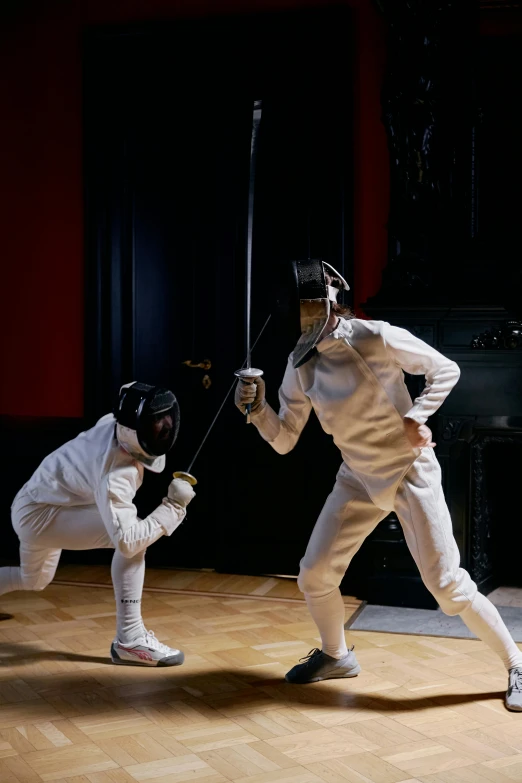 a couple of men standing on top of a wooden floor, fencing, striking, gold, getty images