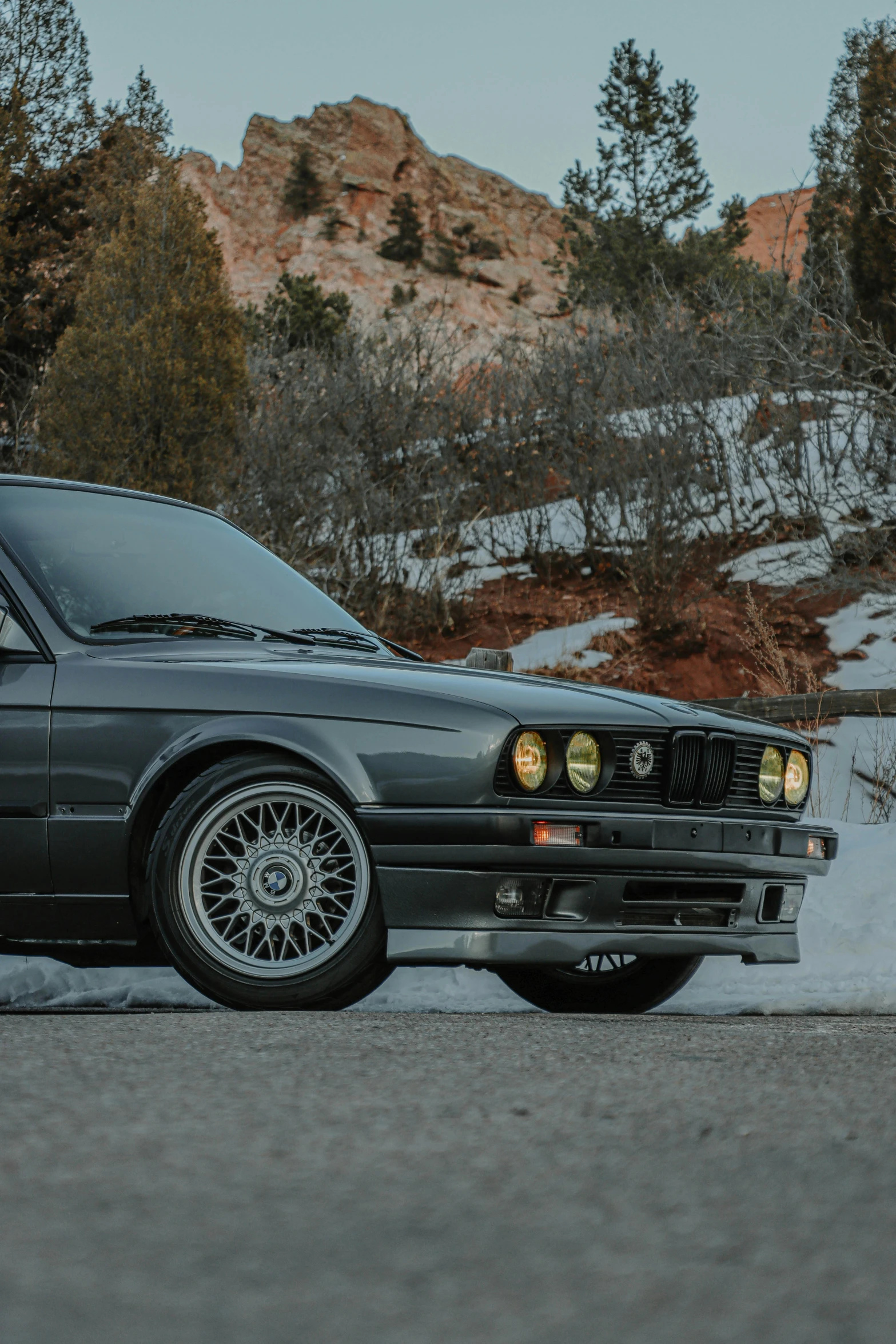a black car parked on the side of the road, by Sven Erixson, unsplash contest winner, renaissance, bmw e 3 0, profile image, snow glow, steel gray body