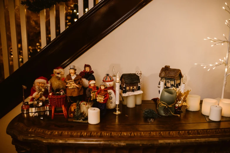 a table topped with christmas figurines and candles, by Emma Andijewska, pexels contest winner, staircase, cottagecore, casually dressed, gif