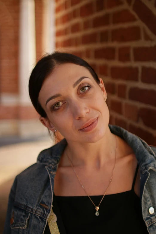 a woman standing in front of a brick wall, nika maisuradze, headshot, stoya, avatar image