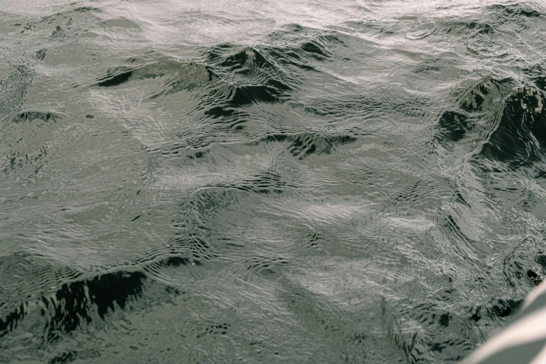 a man riding a surfboard on top of a body of water, an album cover, inspired by Vija Celmins, unsplash, hyperrealism, extremely detailed water texture, ignant, james nares, texture detail