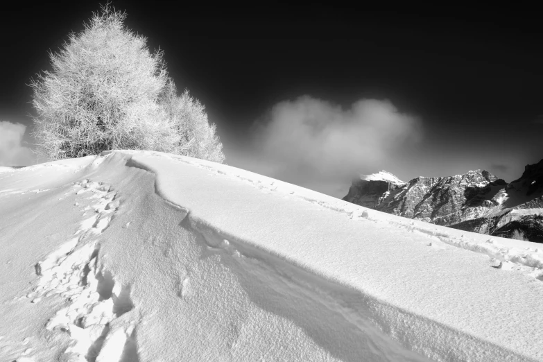 a black and white photo of a snowy road, a black and white photo, by Cedric Peyravernay, snowy apennines, detailed medium format photo, infra - red, top of the mountain