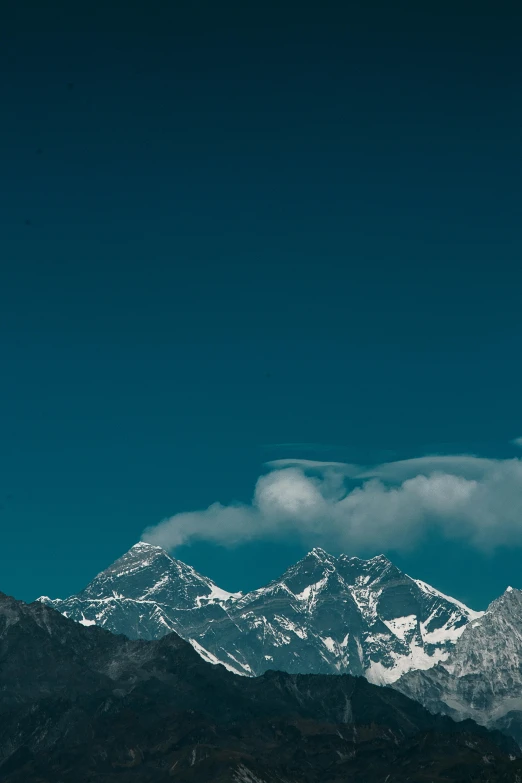 a mountain range with snow capped mountains in the background, an album cover, trending on unsplash, nepal, cloudless sky, wallpaper mobile, multiple stories