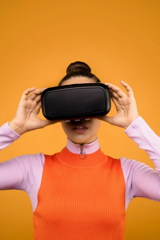 a woman is wearing a virtual reality headset, by Carey Morris, trending on pexels, hypermodernism, in front of an orange background, close up to the screen, square, 3 6 0 panorama