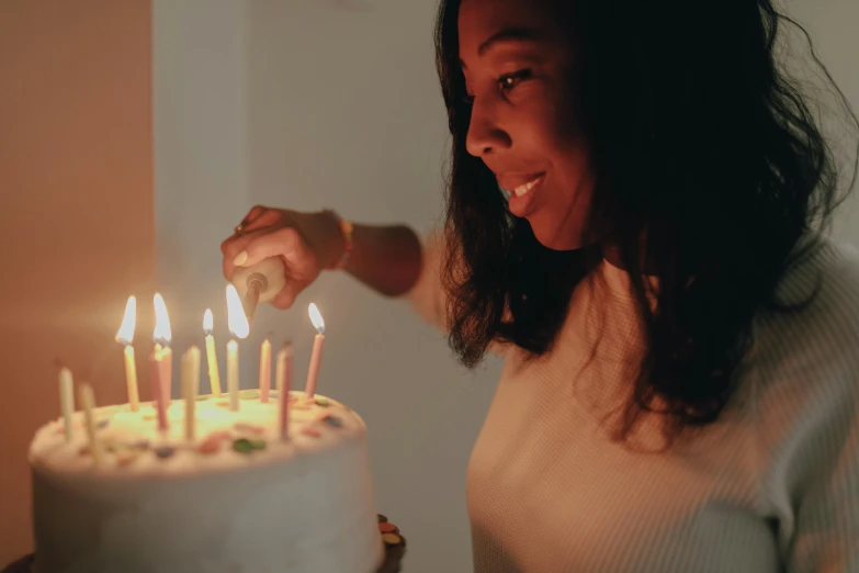 a woman lighting candles on a birthday cake, pexels contest winner, african american young woman, high quality screenshot, profile image, 30 year old man