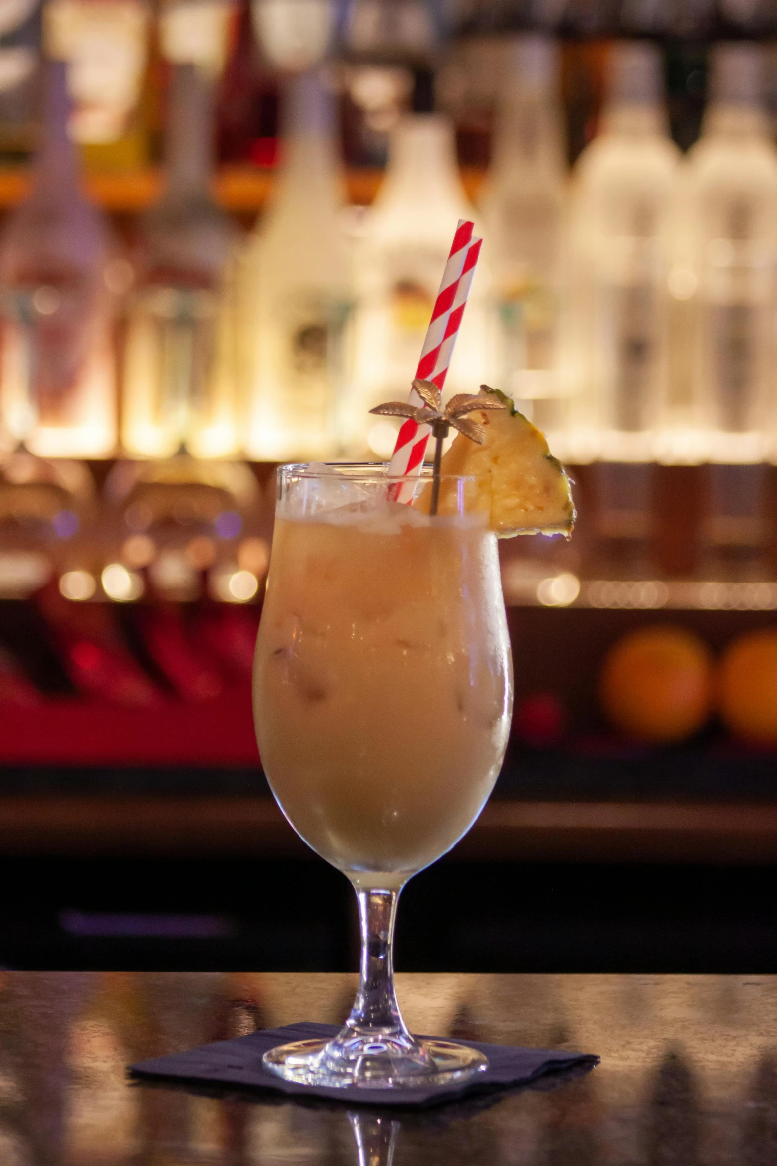 a close up of a drink in a glass on a table, profile image