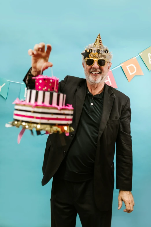 a man in a party hat holding a birthday cake, by Dan Content, trending on unsplash, happening, oldman with mustach, with a crown, plain background, burt reynolds