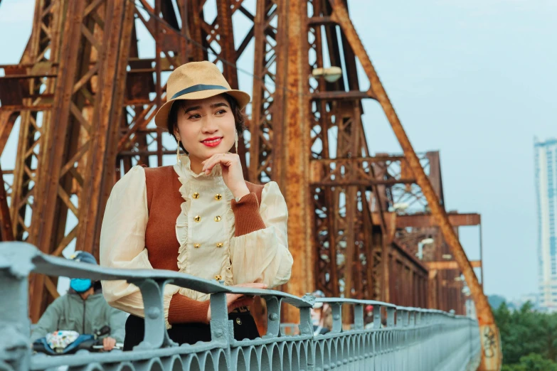 a woman in a hat standing on a bridge, a portrait, inspired by Jiao Bingzhen, pexels contest winner, wearing steampunk attire, in style of lam manh, dressed like in the 1940s, a handsome