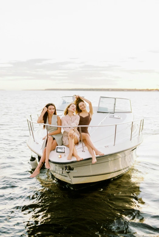 a group of women riding on the back of a boat, pexels contest winner, model pose, espoo, how pretty, product introduction photo