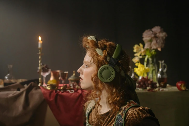 a woman wearing headphones sitting in front of a table, inspired by Gerrit Dou, renaissance, persephone, **cinematic, medieval feast, press shot