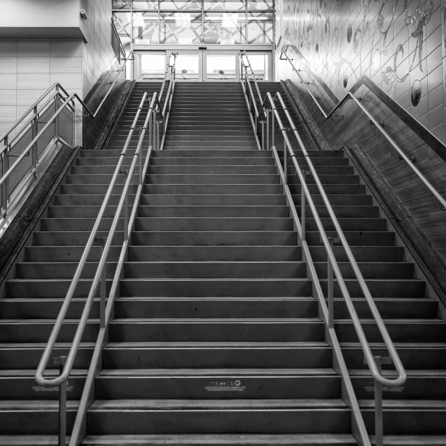 a black and white photo of a set of stairs, central station in sydney, california;, photo taken in 2 0 2 0, true realistic image