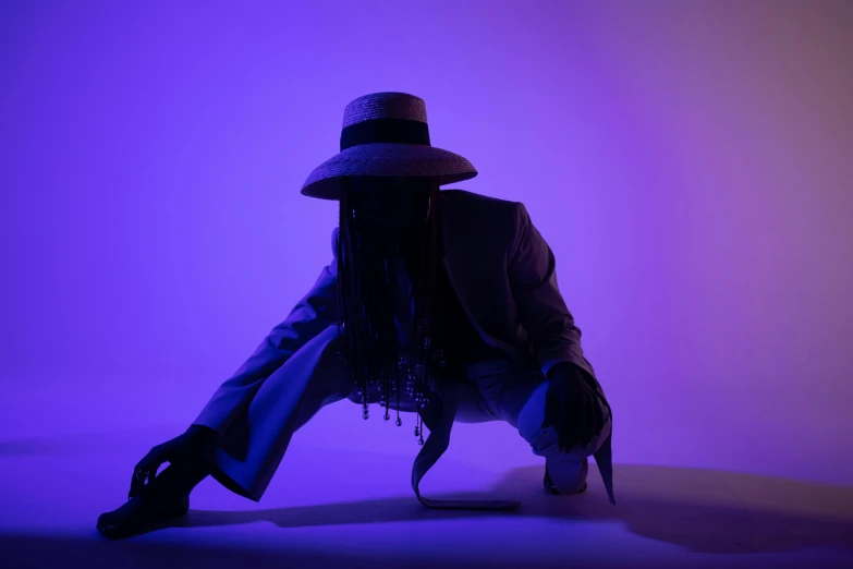 a woman in a hat sitting on the ground, an album cover, by Peter Alexander Hay, unsplash, afrofuturism, blue and purple lighting, a suited man in a hat, buckethead, standing in a dimly lit room