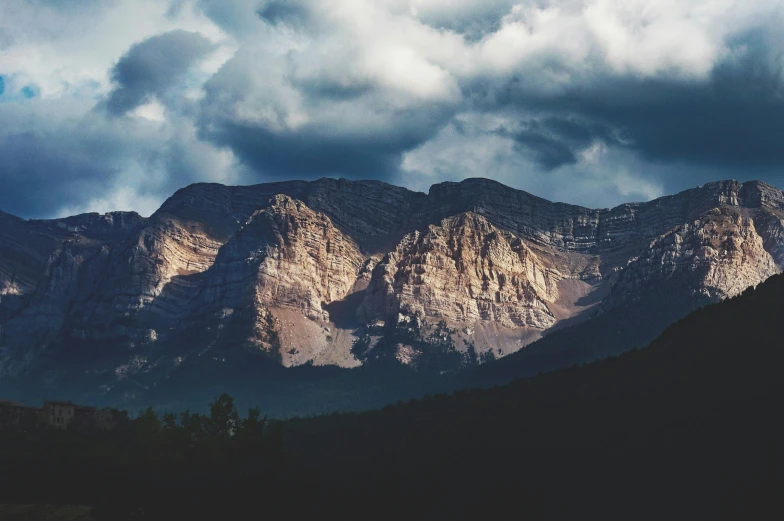 a view of a mountain range under a cloudy sky, by Andrew Domachowski, pexels contest winner, baroque, banff national park, dimly lit, 2 0 0 0's photo, multiple stories