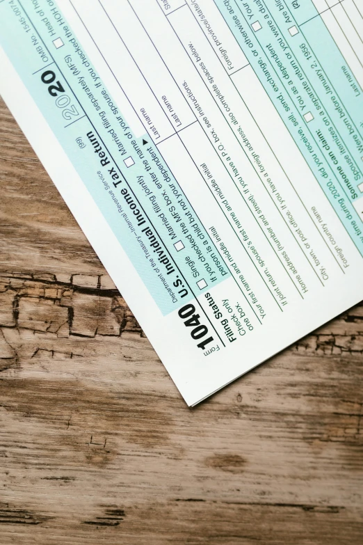 a tax form sitting on top of a wooden table, by Jason Felix, pexels, panel, instagram photo, thumbnail, print ready