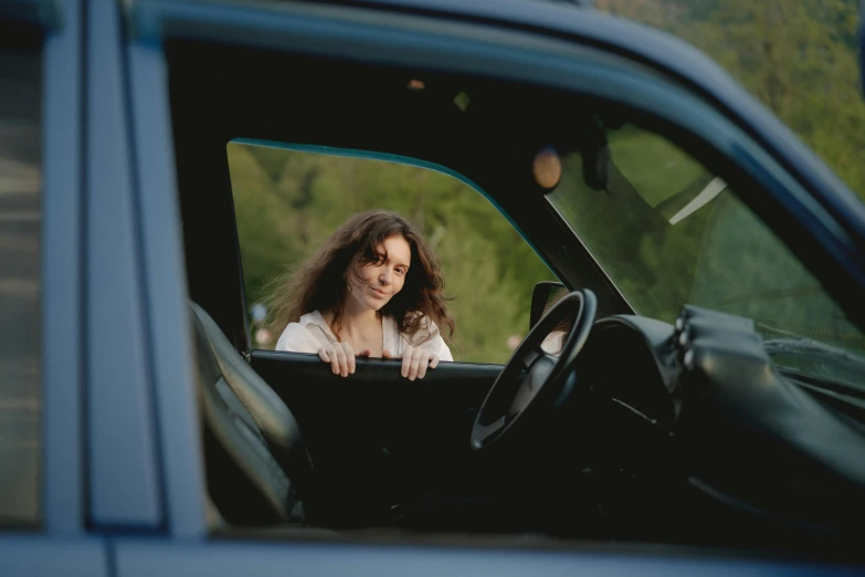 a woman sitting in the driver's seat of a blue truck, pexels contest winner, renaissance, avatar image, high resolution image, casually dressed, 1 9 7 0 s car window closeup