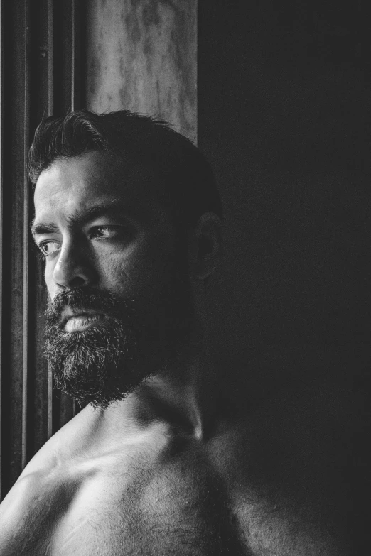 a man with a beard standing in front of a window, pexels contest winner, renaissance, portrait of muscular, a portrait of rahul kohli, marton csokas, black and white image