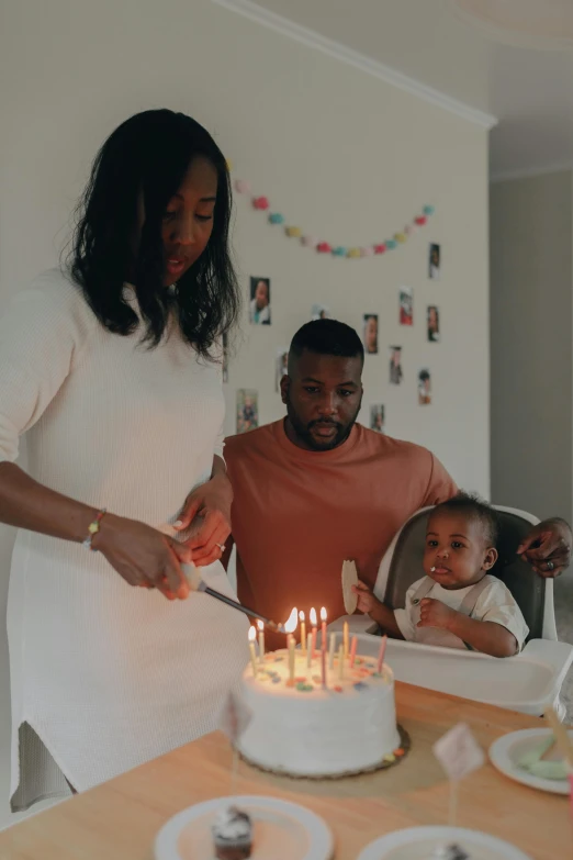 a man and woman cutting a cake with candles, pexels contest winner, father with child, african american, instagram story, casually dressed