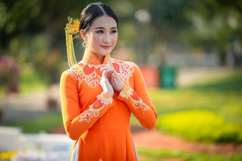 a woman in an orange dress poses for a picture, inspired by Tang Di, pexels contest winner, ao dai, 15081959 21121991 01012000 4k, square, beautiful costume