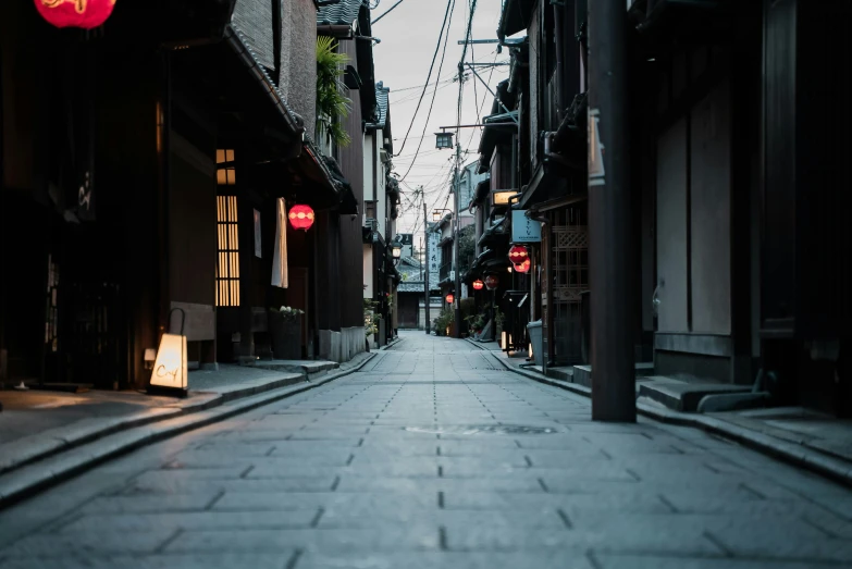 a city street filled with lots of tall buildings, inspired by Watanabe Shōtei, unsplash contest winner, old asian village, calm evening, buildings carved out of stone, gray