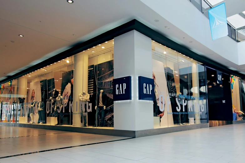 a man riding a skateboard in front of a store, by Gavin Nolan, trending on unsplash, yzy gap, inside building, julian opie, in a mall