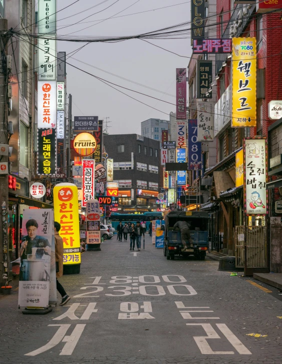 a city street filled with lots of neon signs, a picture, by Jang Seung-eop, old town, grey, clean streets, exterior photo