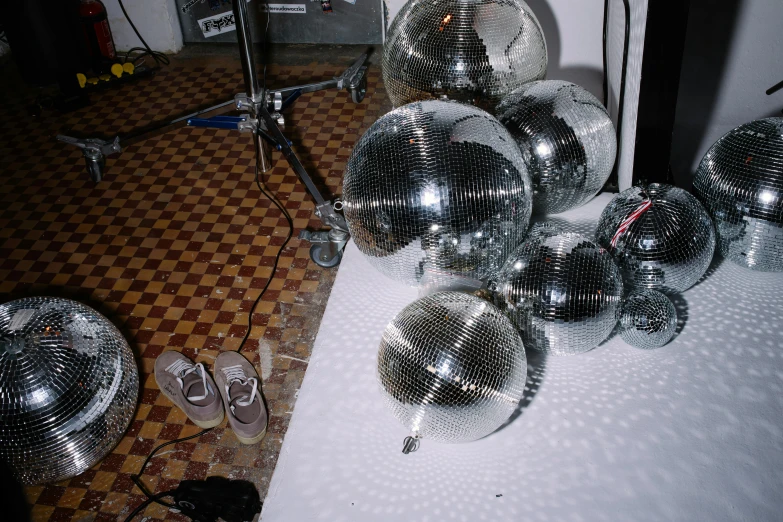 a bunch of disco balls sitting on top of a table, reddit, hyperrealism, sneaker photo, 2000s photo, dj set, 1999 photograph