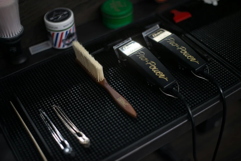 a couple of hair brushes sitting on top of a table, trimmed beard, joel fletcher, luxury equipment, thumbnail