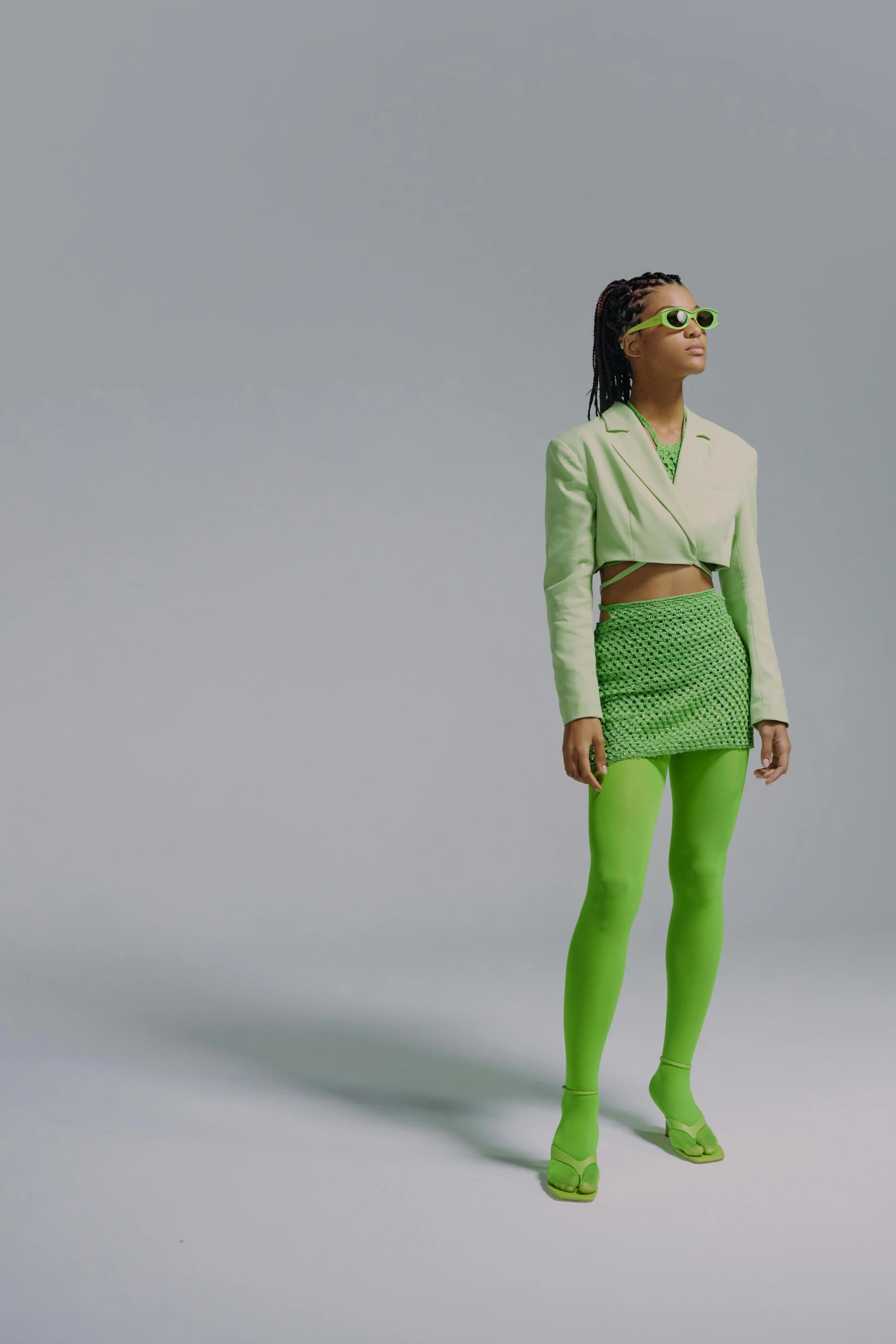 a woman in green tights and a white shirt, wearing shades, off - white collection, ((neon colors)), slide show