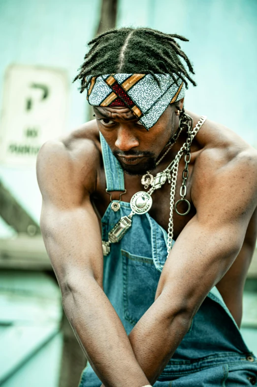 a man with dreadlocks wearing overalls and a bandana, an album cover, trending on pexels, afrofuturism, ((chains)), actor, battle pose, zulu