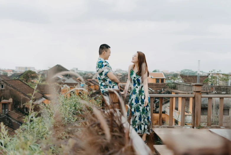 a man and woman standing on top of a roof, pexels contest winner, ao dai, avatar image, batik, long distance photo