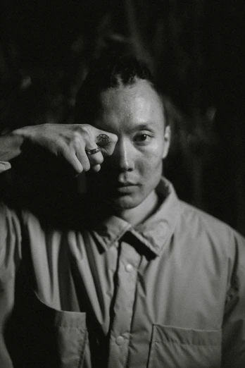 a black and white photo of a man in a shirt, inspired by Li Tiefu, visual art, showing forehead, 4 2 0, dimly - lit, in a menacing pose