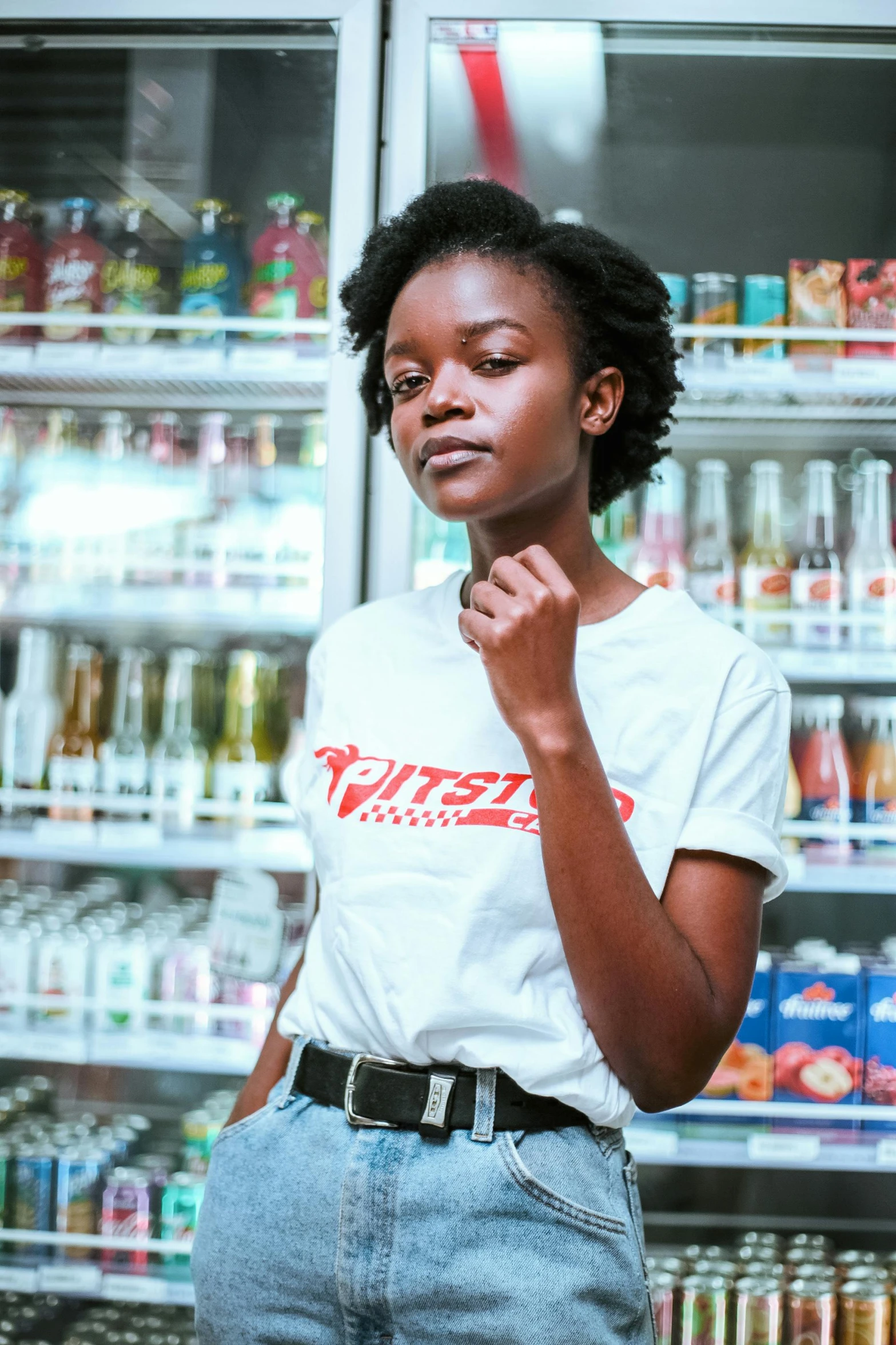 a woman standing in front of a refrigerator, pexels contest winner, brown skinned, graphic tees, stood in a supermarket, yzy gap