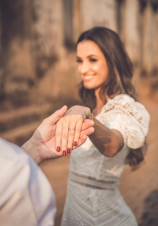 a man and woman holding hands in front of a building, a picture, trending on unsplash, renaissance, brazilian, engagement ring ads, square, historical setting