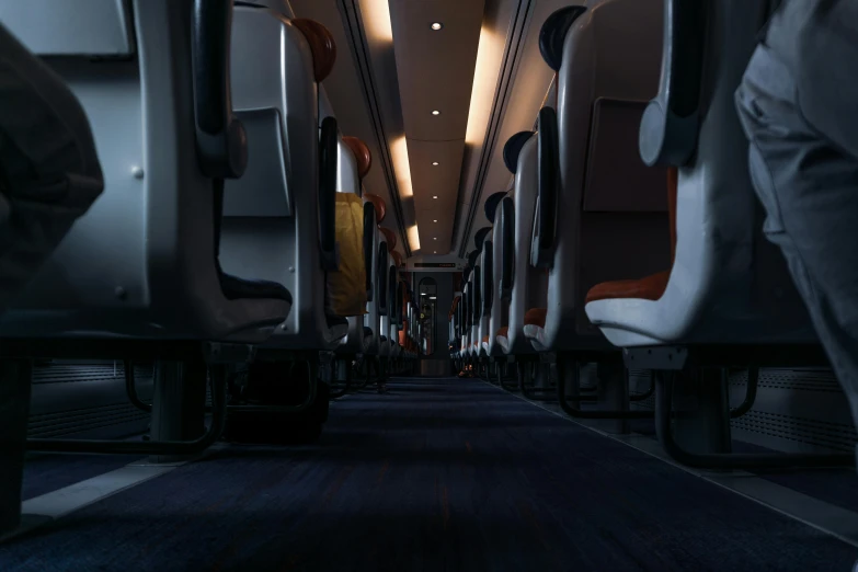 the inside of an airplane with rows of seats, unsplash contest winner, photorealism, 8 k. volumetric lighting. dark, high speed trains, cinematic:0.9|unreal engine, train far