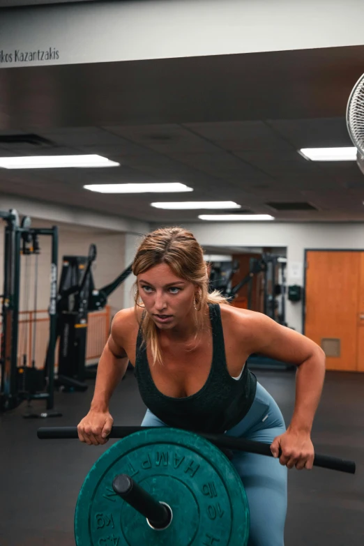 a woman lifting a barbell in a gym, by Robbie Trevino, lynn skordal, panoramic view of girl, kailee mandel, ox