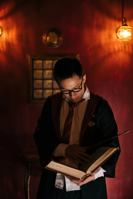 a man reading a book in a dark room, happening, gryffindor, huifeng huang, wearing headmistress uniform, spell casting