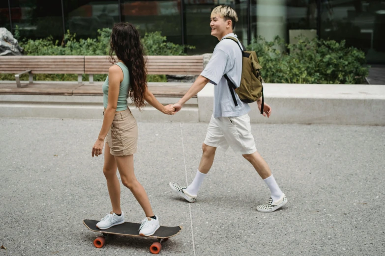 a boy and a girl holding hands on a skateboard, trending on pexels, happening, handsome man, asian female, thumbnail, high quality image