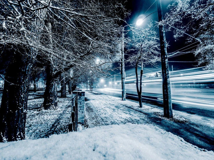 a street filled with lots of snow next to trees, by Adam Marczyński, light trails, thumbnail, trams ) ) ), scary sharp icy