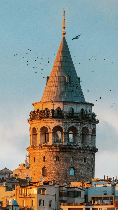 a very tall tower with a lot of birds flying around it, inspired by Kerembeyit, pexels contest winner, turkey, round-cropped, telephoto, a quaint