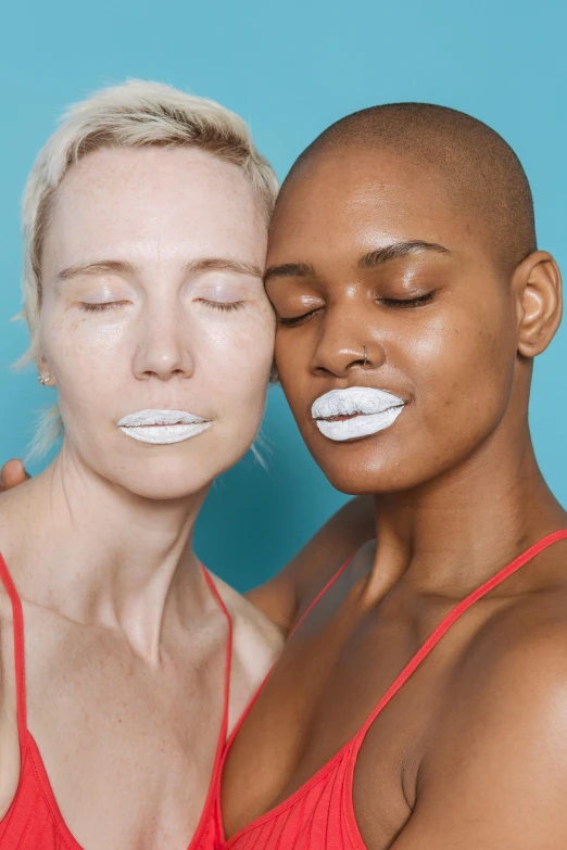 two women who are brushing their teeth together, an album cover, inspired by Vanessa Beecroft, trending on pexels, white facepaint, large lips, diverse, in the style of john baldessari