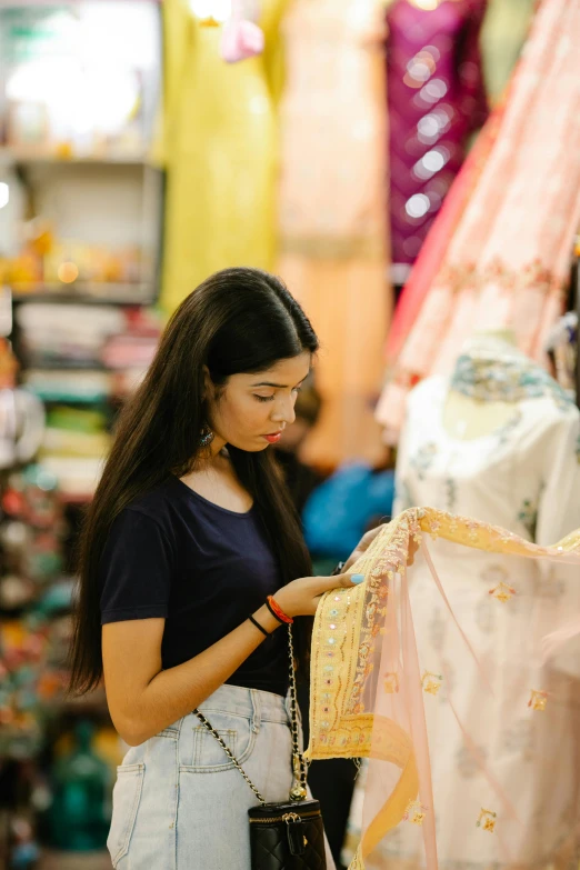 a woman looking at a dress in a store, dressed in a sari, gen z, asian female, - 8