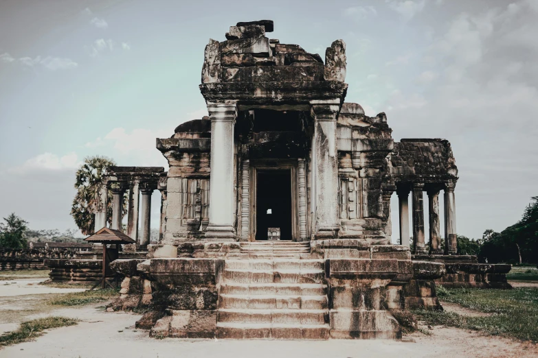 a stone structure sitting in the middle of a field, unsplash contest winner, baroque, angkor thon, background image, colonnade, sitting on temple stairs