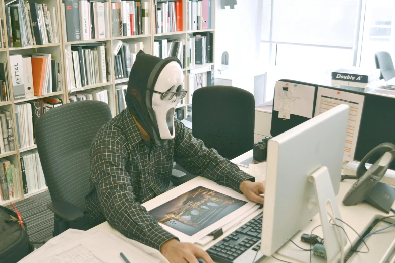 a man sitting at a desk in front of a laptop computer, inspired by Pietro Longhi, pexels contest winner, wearing bandit mask, award winning horror photography, architect, instagram post