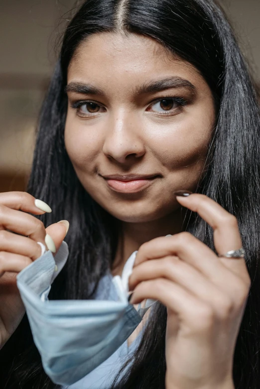 a close up of a person wearing a face mask, tea, young woman with long dark hair, chewing tobacco, promo image