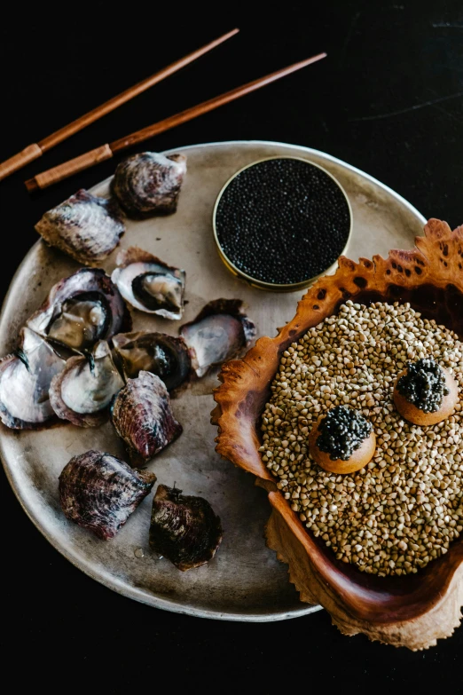 a close up of a plate of food on a table, a still life, unsplash, mingei, an island made of caviar, shells and barnacles, smoky, bao pham